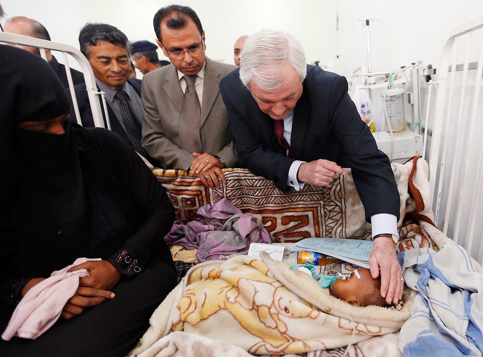 UN humanitarian aid chief Stephen O'Brien, a British diplomat, looking at a child during a visit to the Mother and Child hospital in the Yemeni capital Sanaa