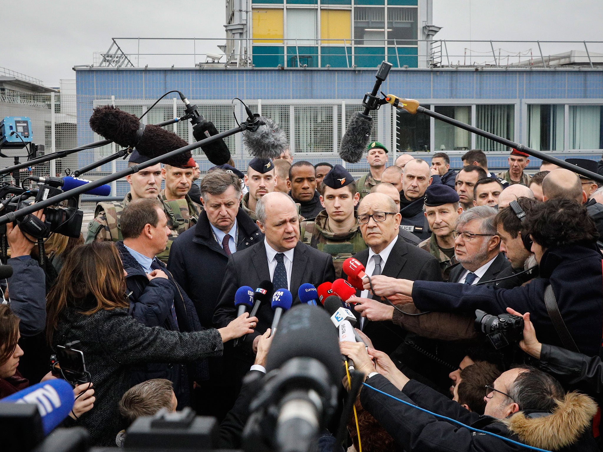 French interior minister Bruno Le Roux and defence minister Jean-Yves le Drian answer questions at Paris Orly Airport