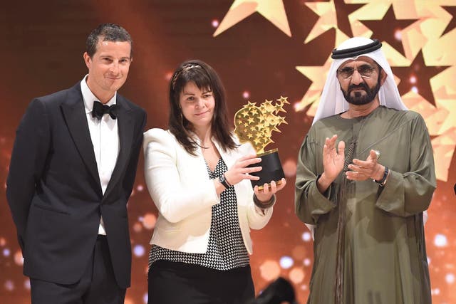 Maggie MacDonnell with United Arab Emirates Vice President, Sheikh Mohammad Bin Rashid Al Maktoum, and Bear Grylls - who delivered the trophy via helicopter
