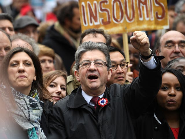French presidential election candidate for the far-left coalition 'La France insoumise' Jean-Luc Melenchon raises his fist as he takes part in the March for the 6th Republic
