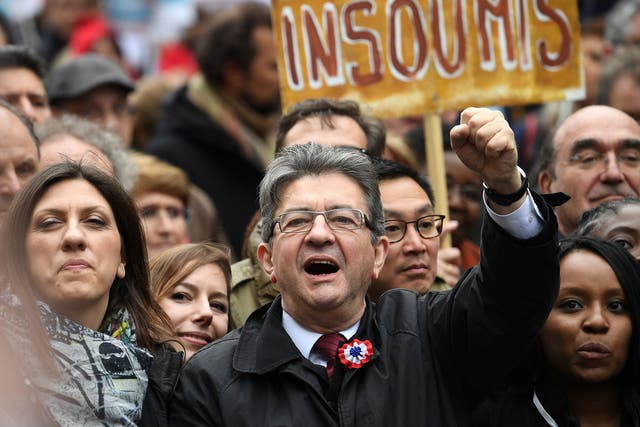 French presidential election candidate for the far-left coalition 'La France insoumise' Jean-Luc Melenchon raises his fist as he takes part in the March for the 6th Republic