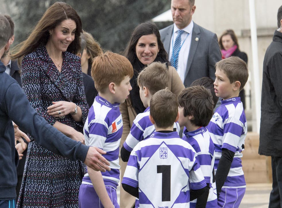 Kate Middleton pictured in Paris, where she joined in with schoolchildren playing rugby