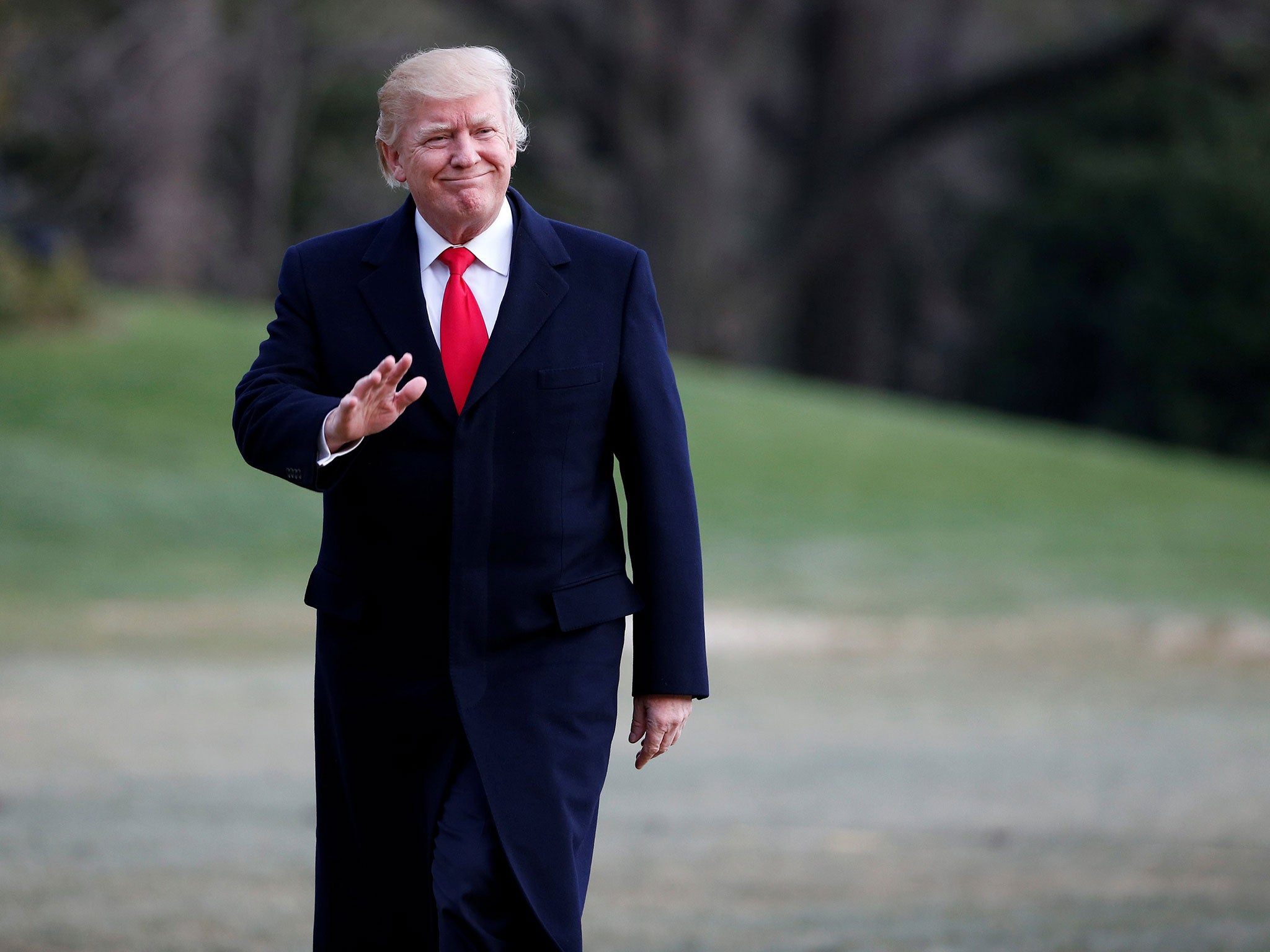 Donald Trump waves as he walks from Marine One upon his return to the White House in Washington, 19 March, 2017