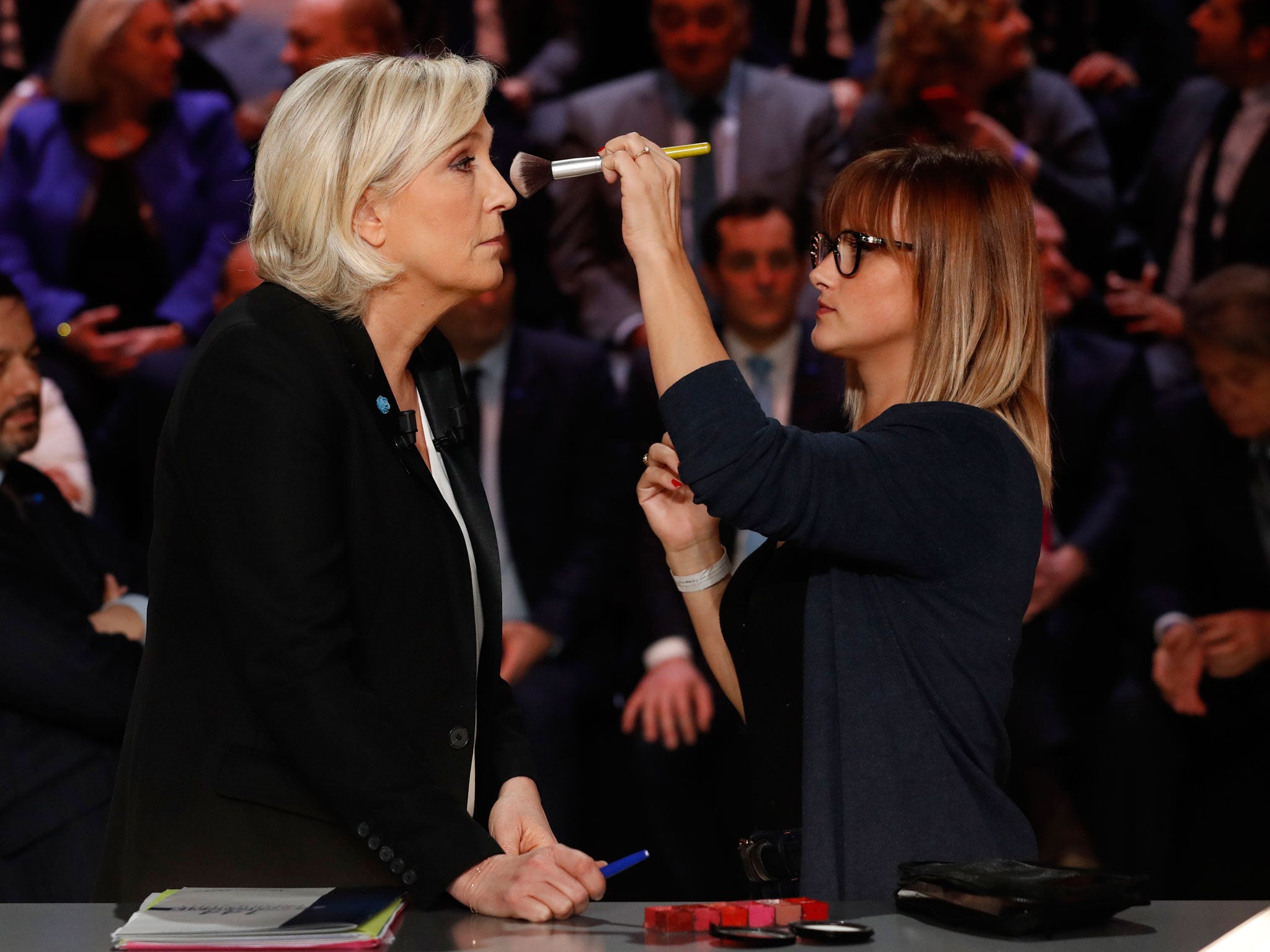 Marine Le Pen receives make-up prior to the start of the TV debate