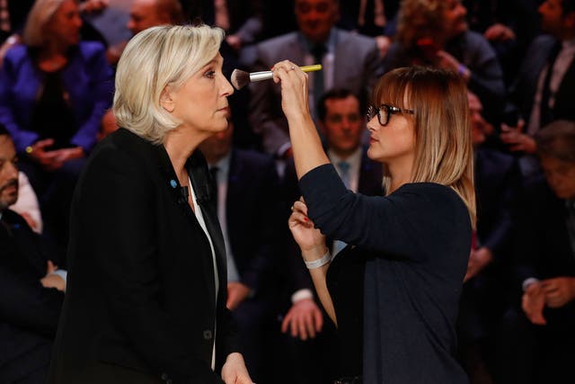 Marine Le Pen receives make-up prior to the start of the TV debate