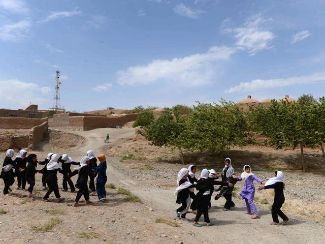 Afghan school girls play outside after classes at Guzara district of Herat, Afghanistan