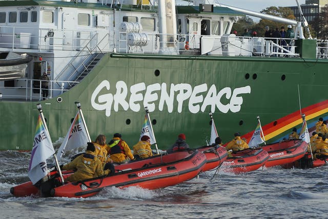 The Rainbow Warrior III, the newest ship of the enivornmental conservation organisation Greenpeace, accompanied by activists on its way to port in Hamburg