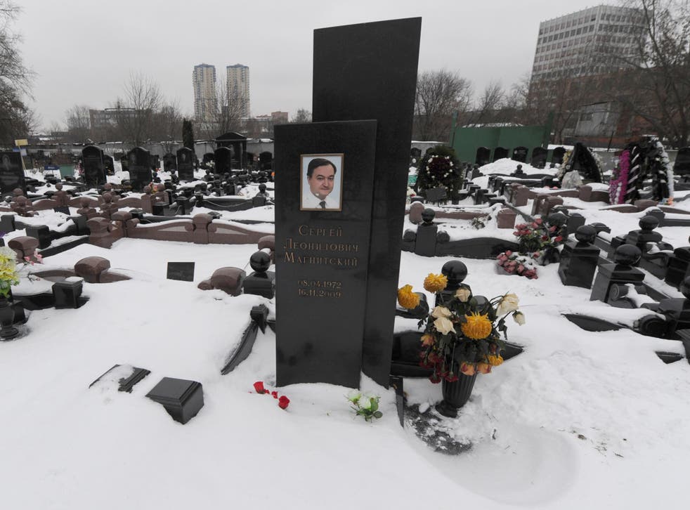 The snow-clad grave of Russian lawyer Sergei Magnitsky with his portrait on the tomb