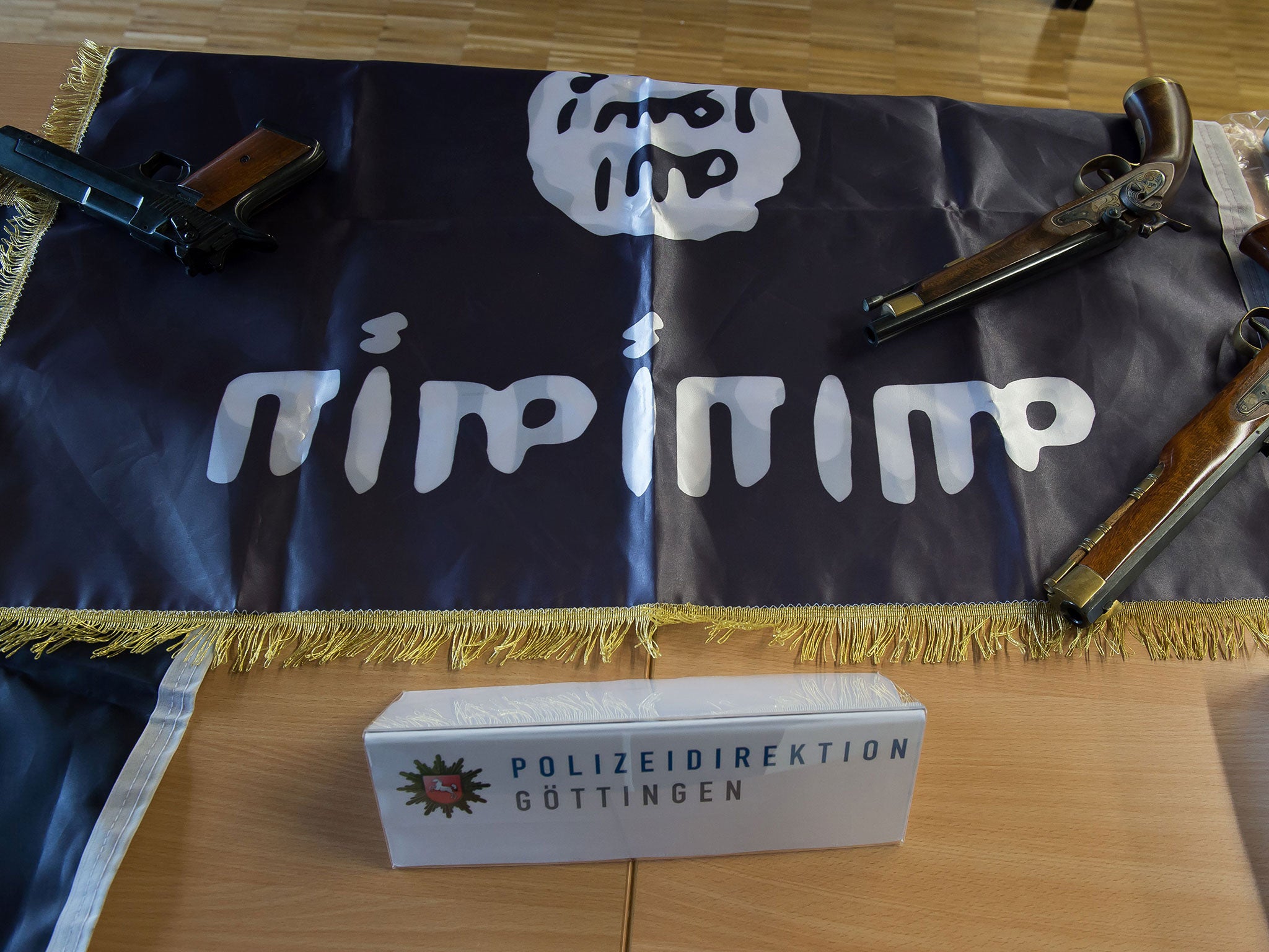 Confiscated weapons and an Isis flag seized in Gottingen, Germany, by police investigating Algerian and Nigerian men suspected of planning a terror attack