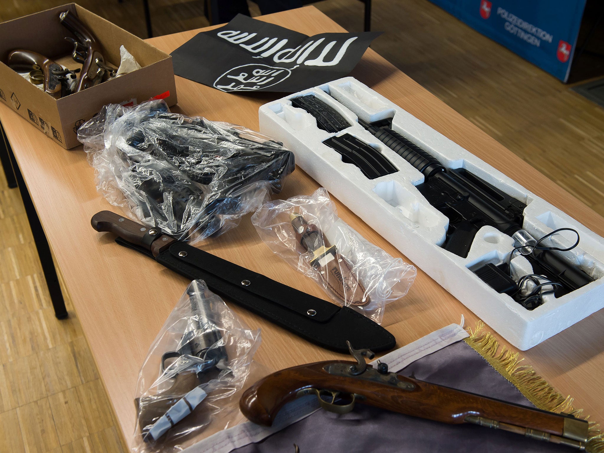 Confiscated weapons and an Isis flag seized in Gottingen, Germany, by police investigating Algerian and Nigerian men suspected of planning a terror attack