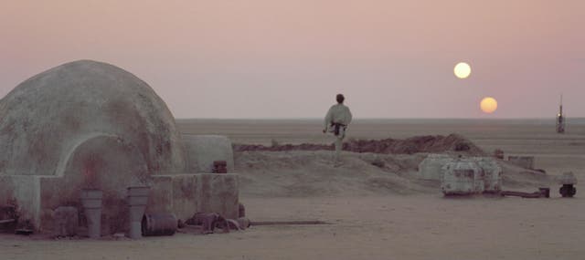 <p>Luke Skywalker staring at Tatooine’s horizon in ‘Star Wars: A New Hope’. The light and dark suns can be interpreted as the personification of the light and dark sides of the force </p>