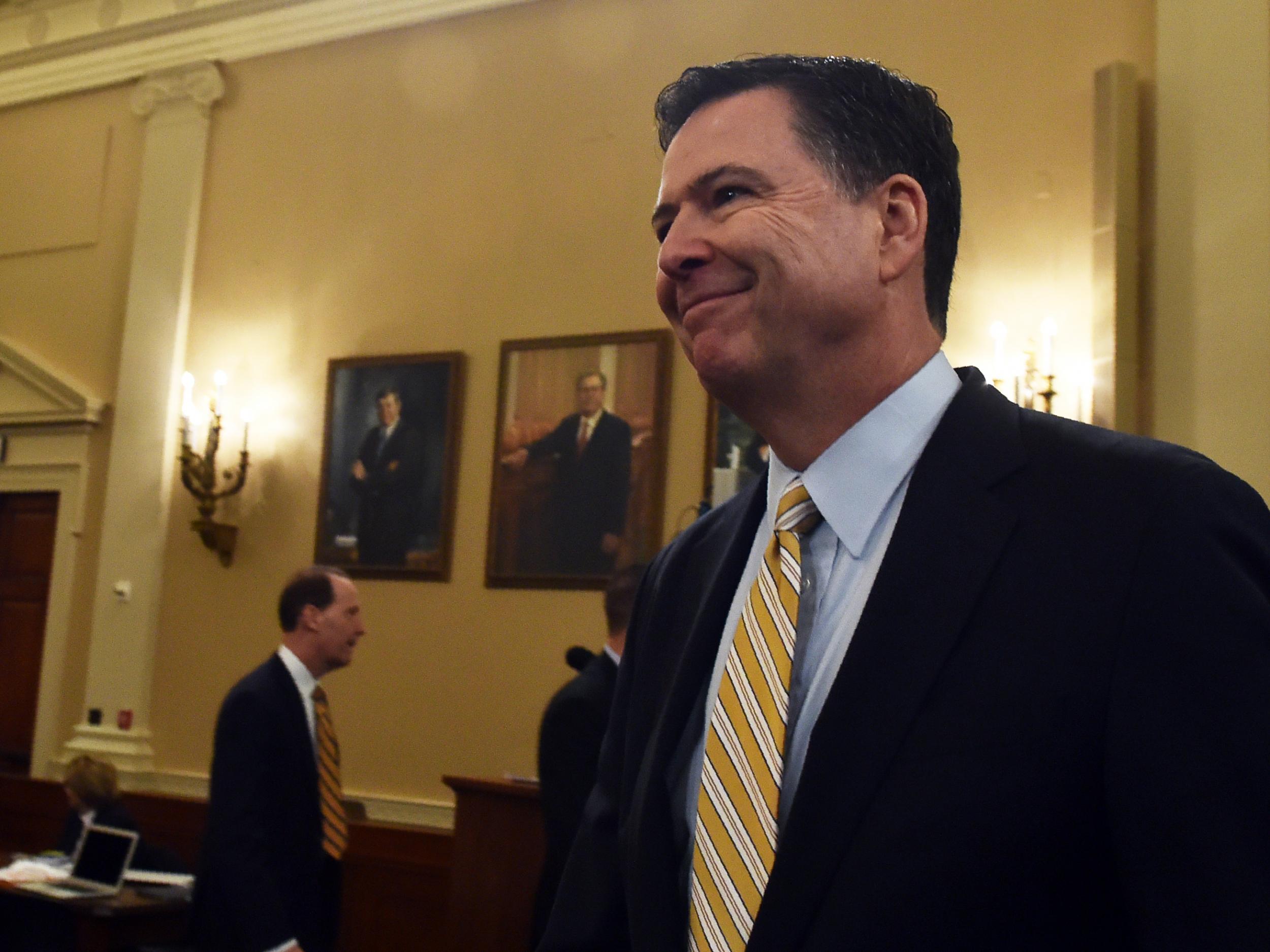 FBI Director James Comey smiles after a break in the House Permanent Select Committee on Intelligence hearing on Russian actions in the 2016 election campaign