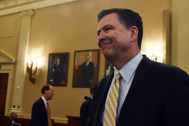 FBI Director James Comey smiles after a break in the House Permanent Select Committee on Intelligence hearing on Russian actions in the 2016 election campaign