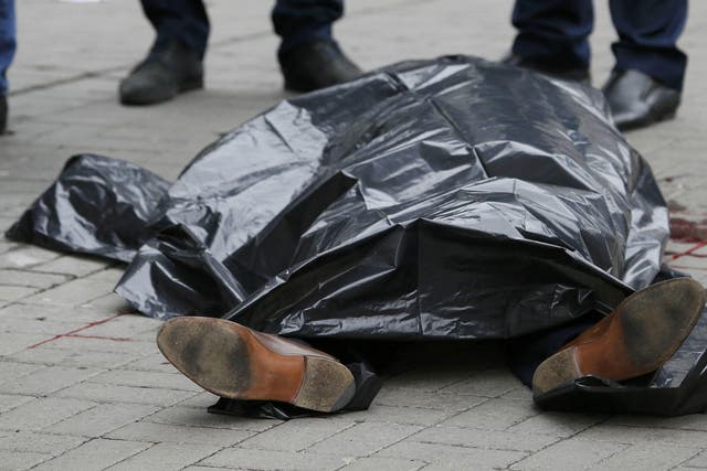 The covered body of Denis Voronenkov is seen outside a hotel in central Kiev