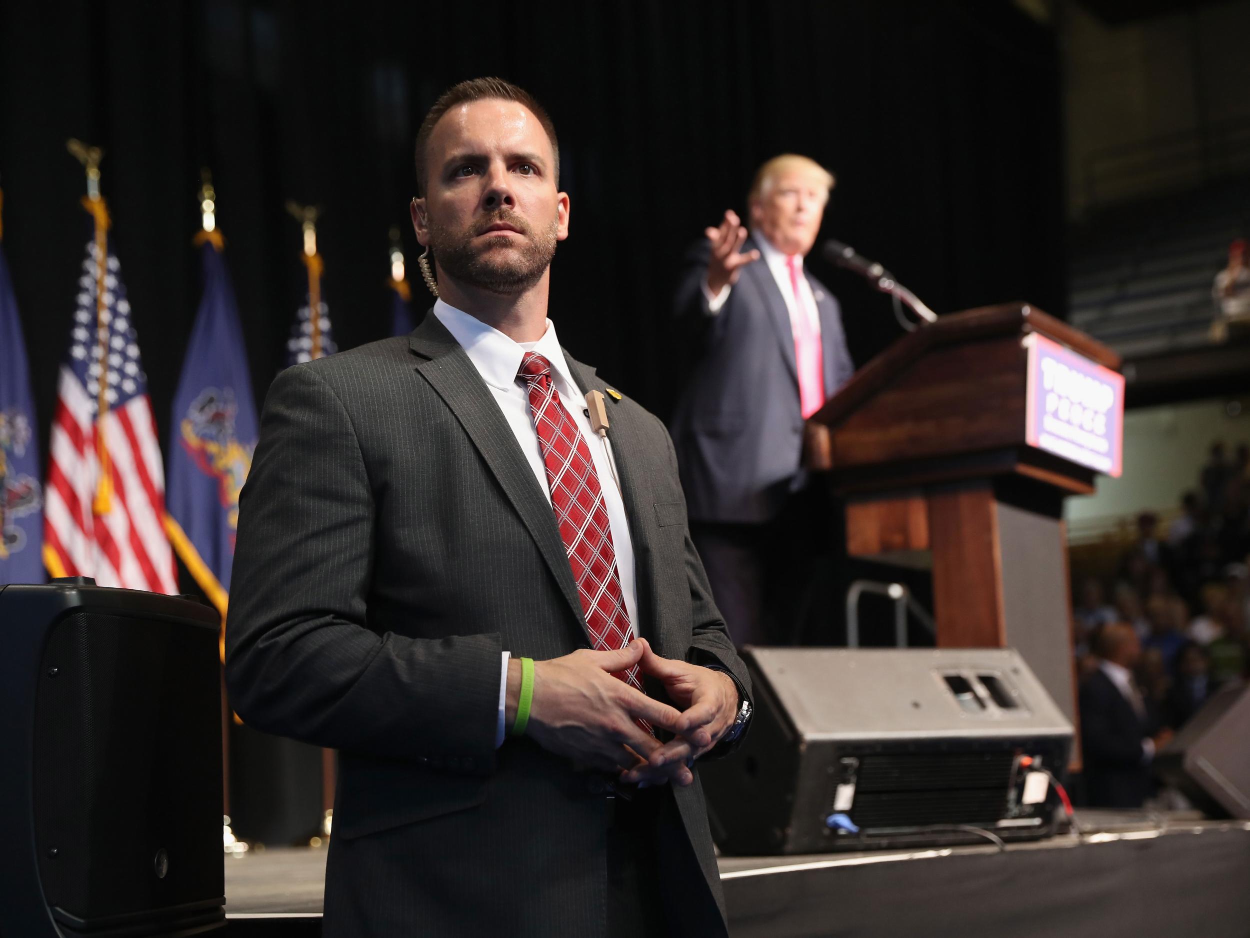 A Secret Service agent stands alert during a speech given by Mr Trump