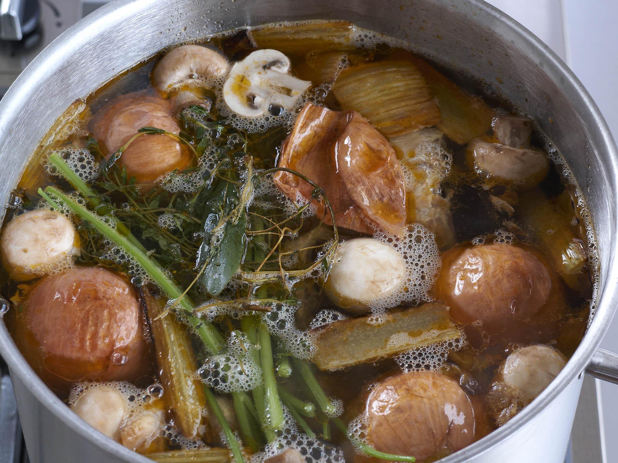 8. Gently simmering the stock, ensuring the bones and vegetables are covered in liquid