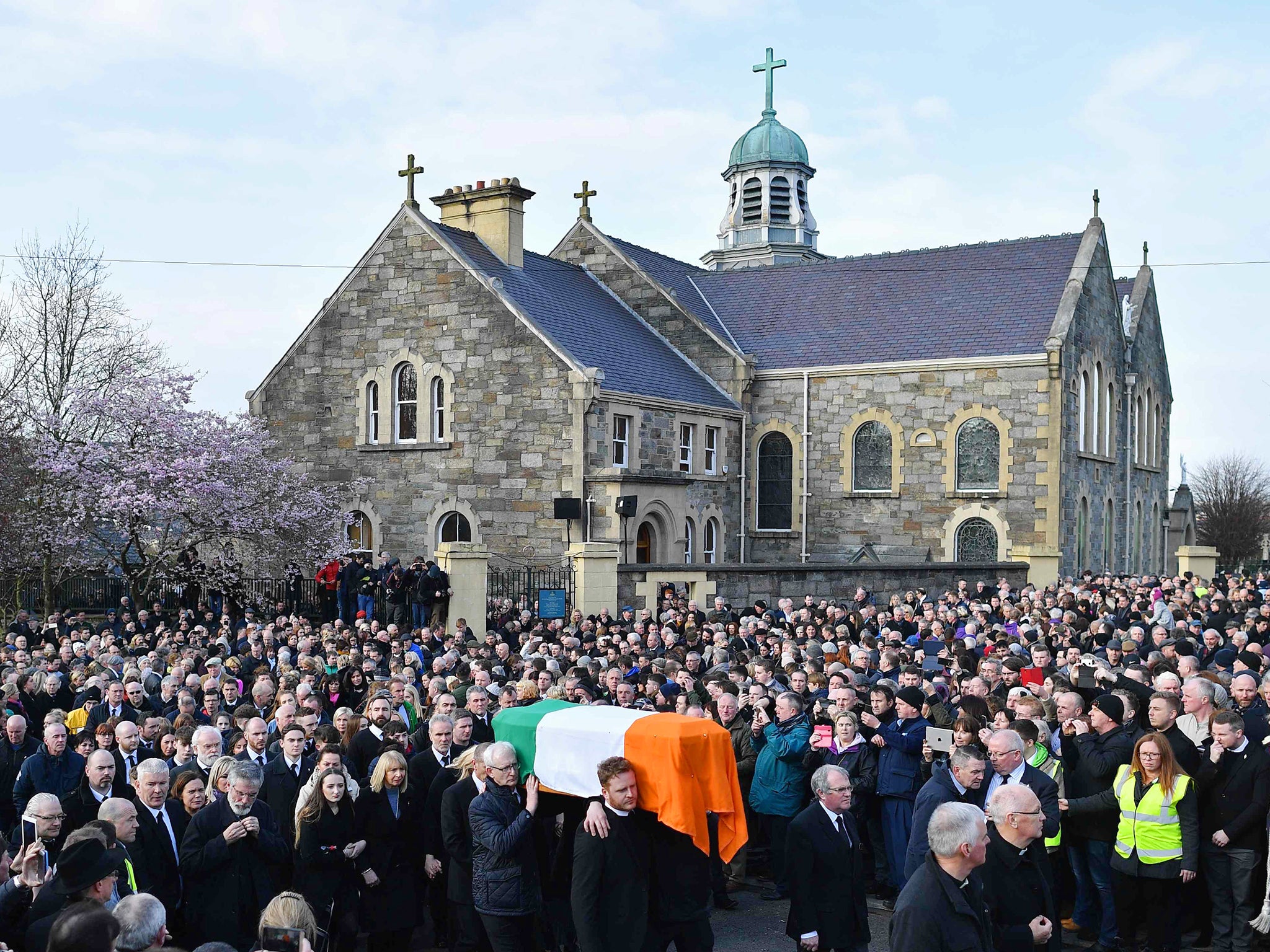 The funeral procession leaves St Columba's Church Long Tower with the coffin after the funeral of former Northern Ireland Deputy First Minister Martin McGuinness in Derry, Northern Ireland