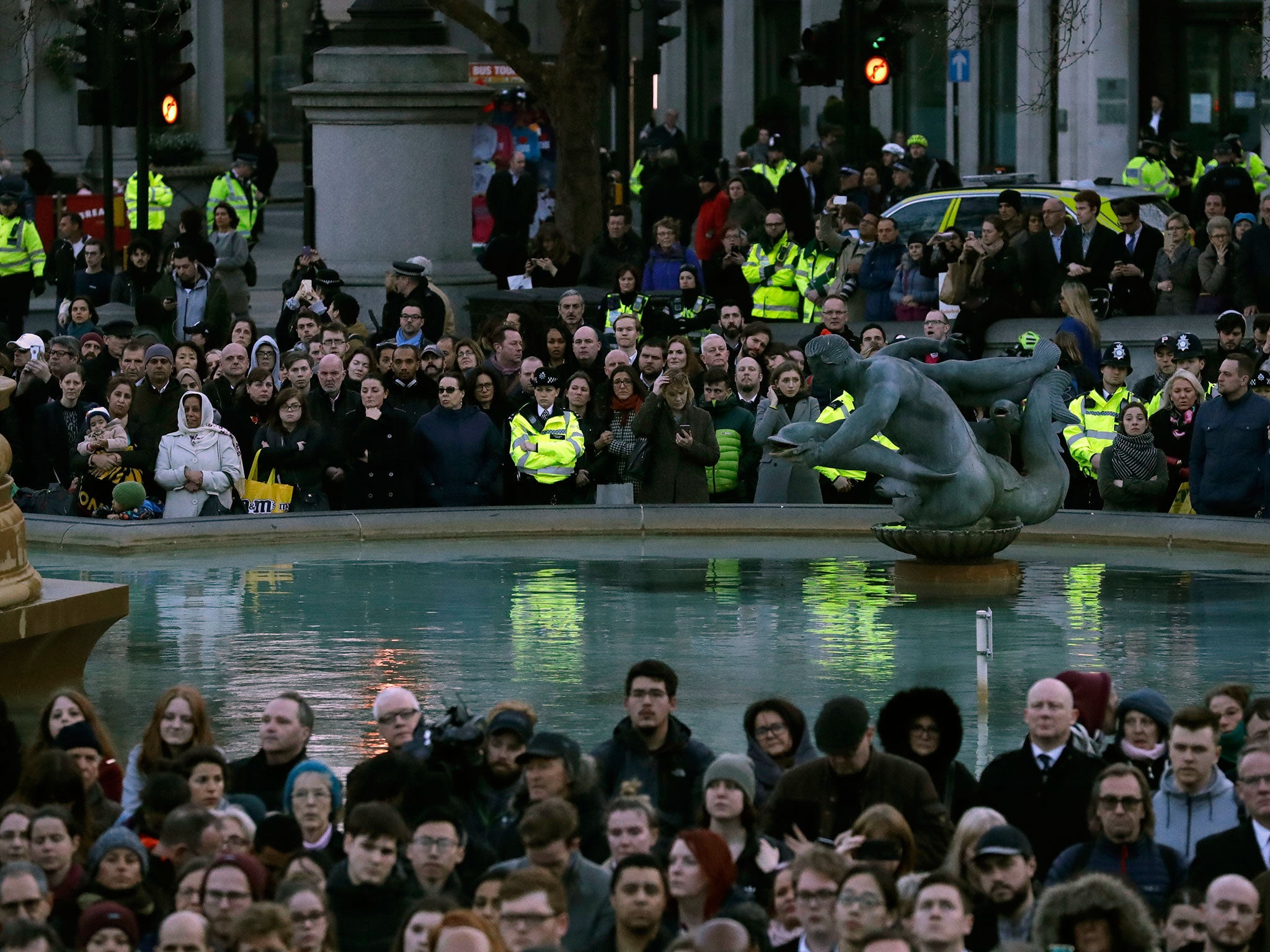 Police join the crowds at a vigil for the victims of Wednesday's attack, at Trafalgar Square in London, Thursday, March 23, 2017