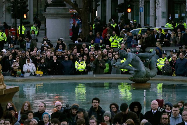 Police join the crowds at a vigil for the victims of Wednesday's attack, at Trafalgar Square in London, Thursday, March 23, 2017