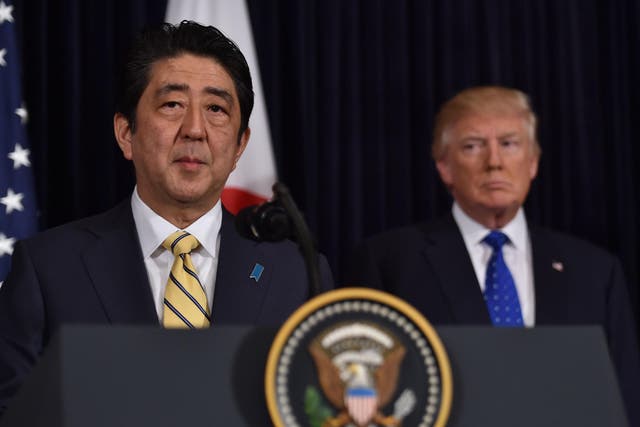 Japanese Prime Minister Shinzo Abe (L) and US President Donald Trump speak at Trump's Mar-a-Lago resort in Palm Beach, Florida, on February 11, 2017