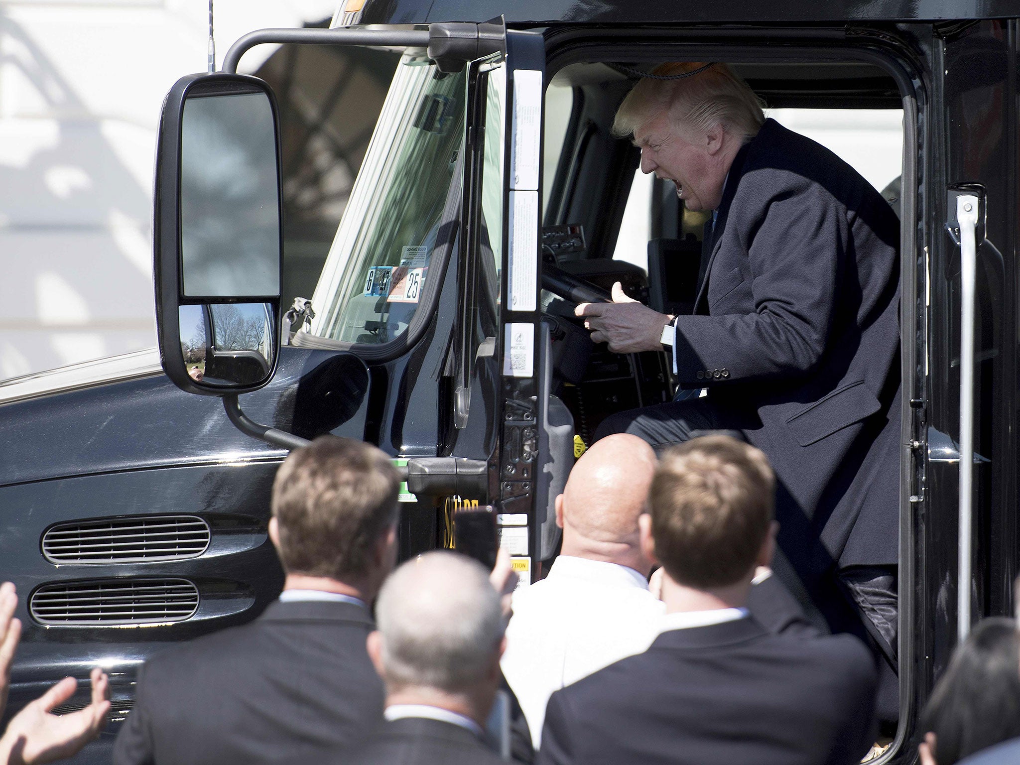 Donald Trump sits in the drivers seat of a semi-truck as he welcomes truckers and CEOs to the White House in Washington, DC, March 23, 2017