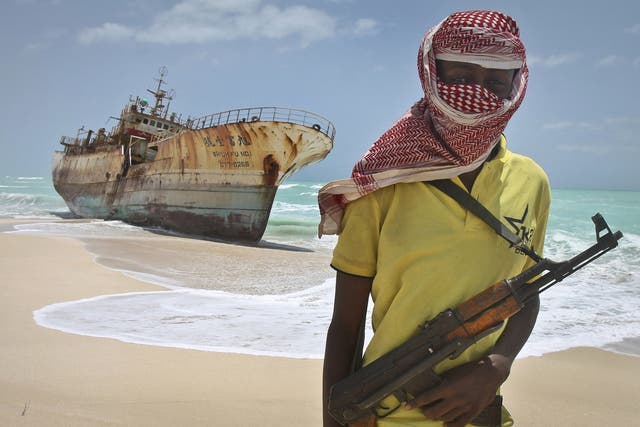 Somali pirates have conducted two hijackings this month, in the biggest spike of activity for almost five years. File image shows pirate Hassan standing next to a Taiwanese fishing vessel in the once-bustling pirate den of Hobyo, Somalia, September 2012