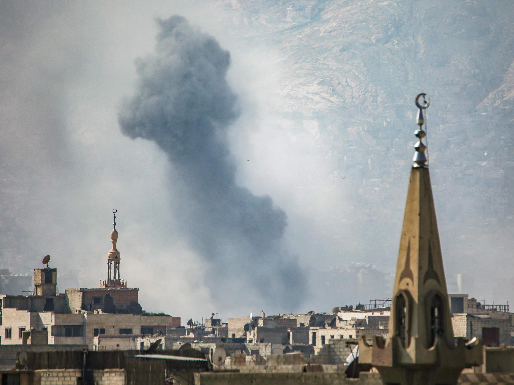 A general view shows moke rising from buildings following an air strike on Jobar, a rebel-held district on the eastern outskirts of Damascus