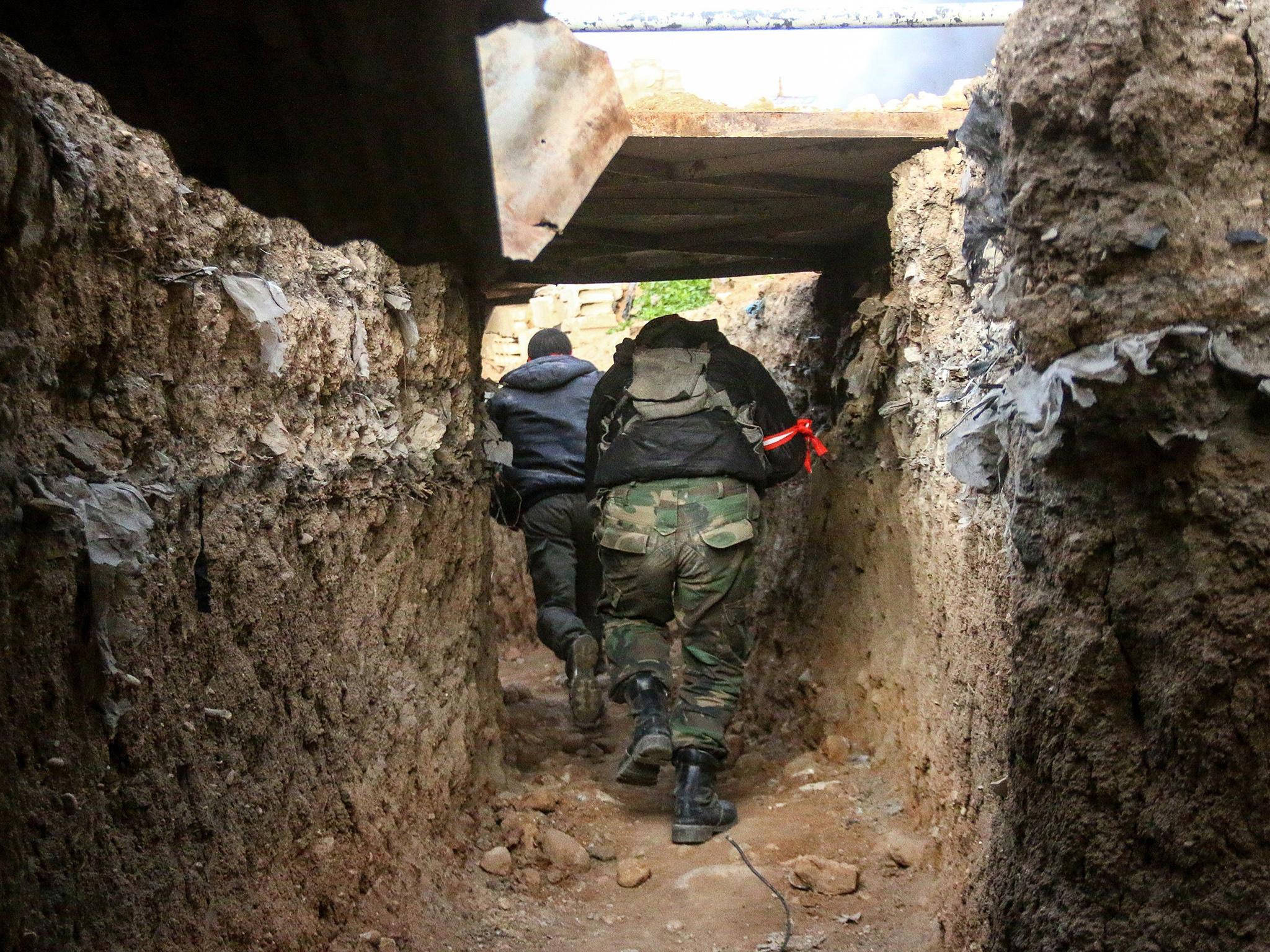 Opposition forces members break through in a tunnel as clashes between opposition forces and Assad regime forces continue in Jobar and Qabun district of Damascus