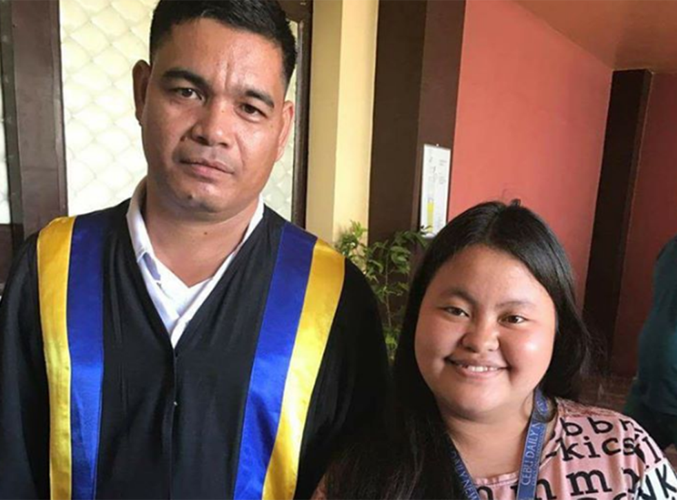 Erwin Macua (left), joined by a local journalist, has graduated with a Bachelor of Elementary Education degree