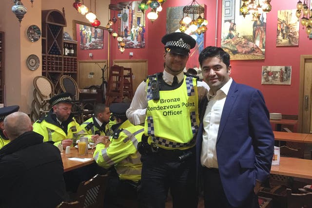 Ibrahim Dogus with police officers in Troia restaurant
