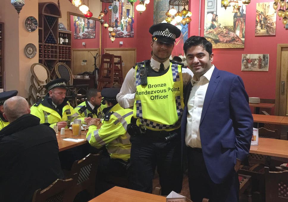 Ibrahim Dogus with police officers in Troia restaurant