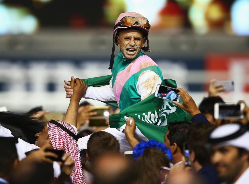 Mike Smith riding Arrogate celebrates winning the Dubai World Cup