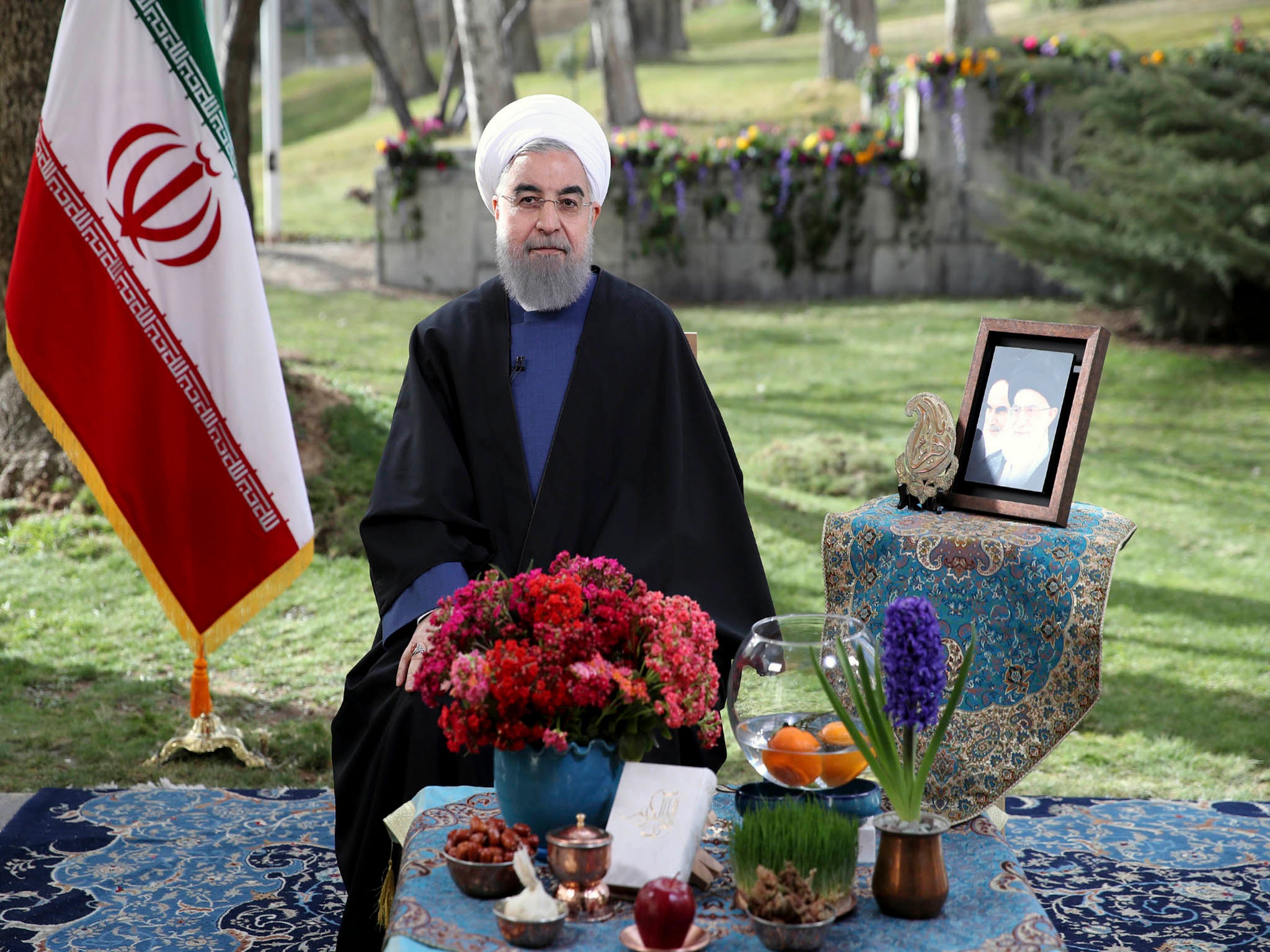 Hassan Rouhani poses for a portrait in a session to deliver a message for the Iranian New Year