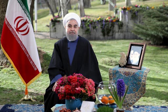 Hassan Rouhani poses for a portrait in a session to deliver a message for the Iranian New Year