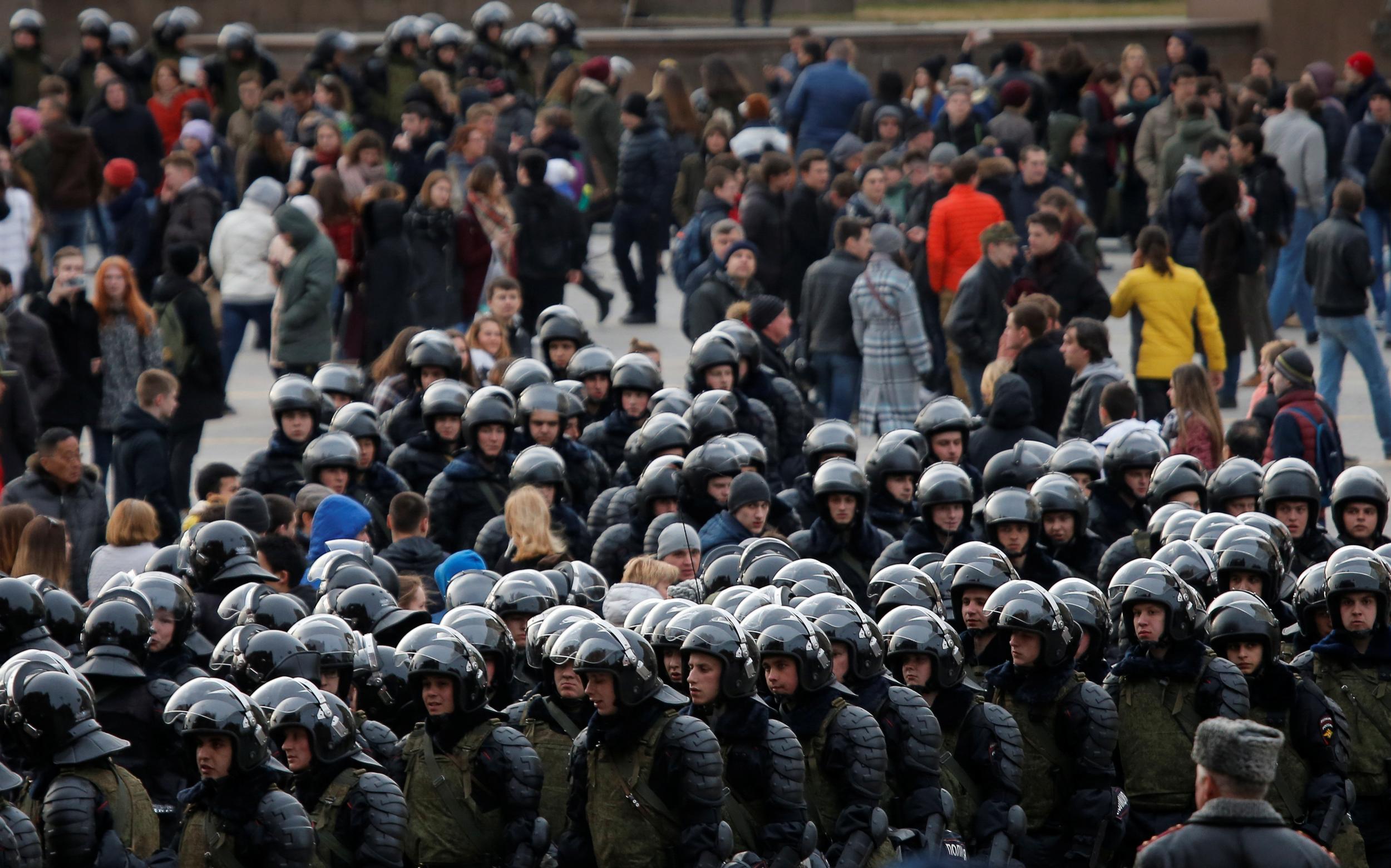 Law enforcement officers gather as they block opposition supporters in Moscow
