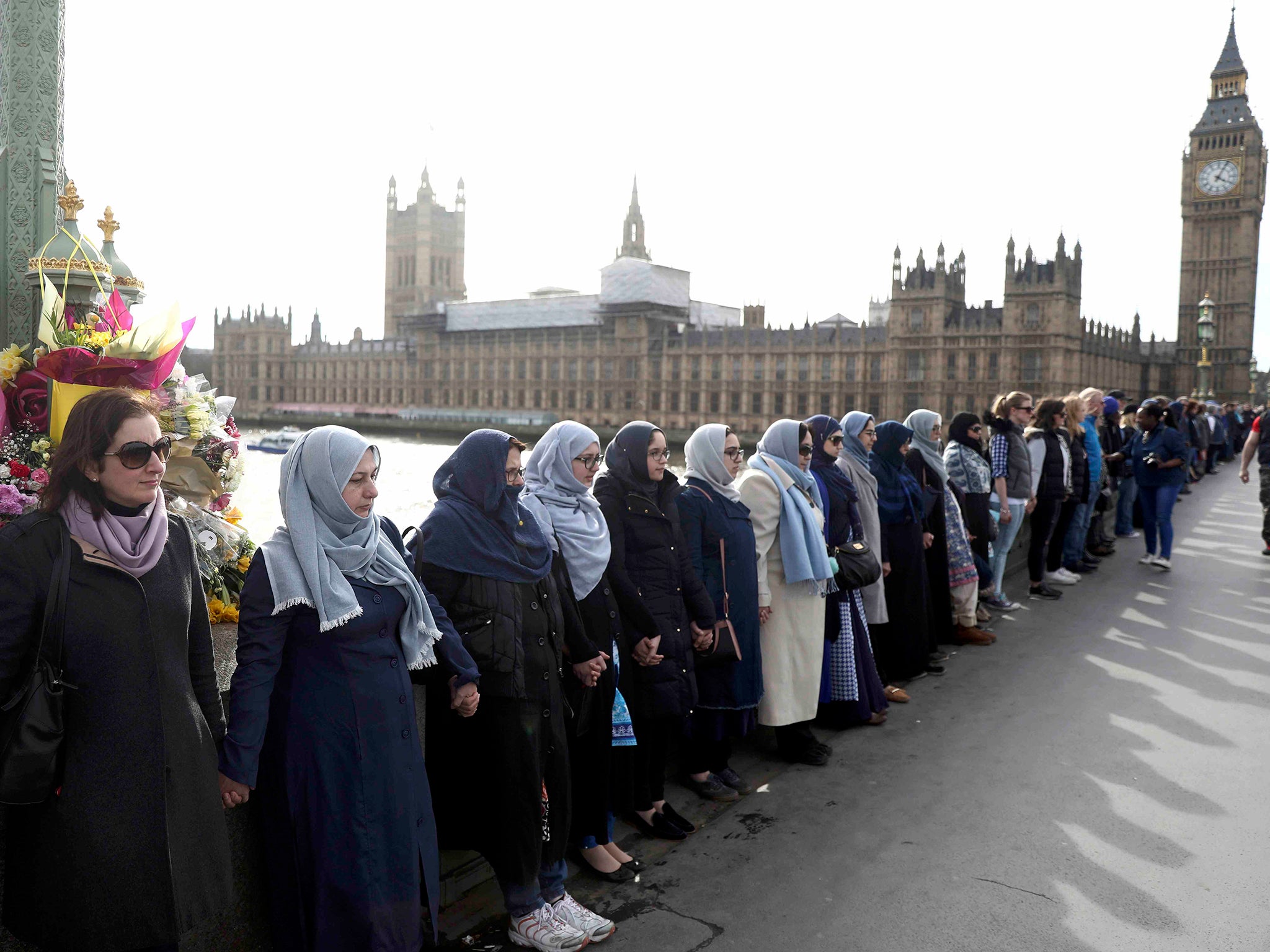 The women held hands in silence to remember victims of the terror attack in Westminster