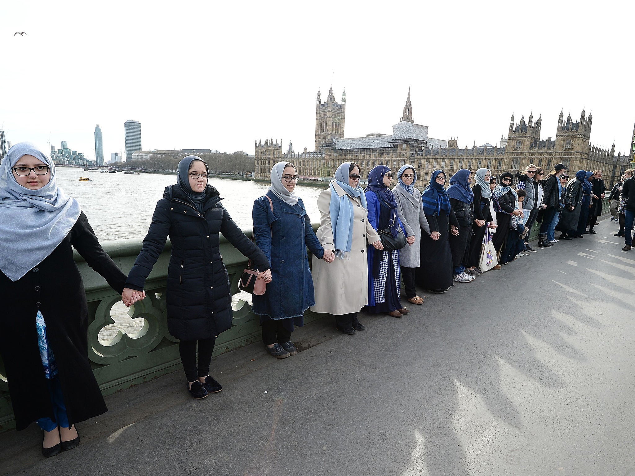 The women, some of whom said they were wearing blue as a symbol of hope, held hands for five minutes