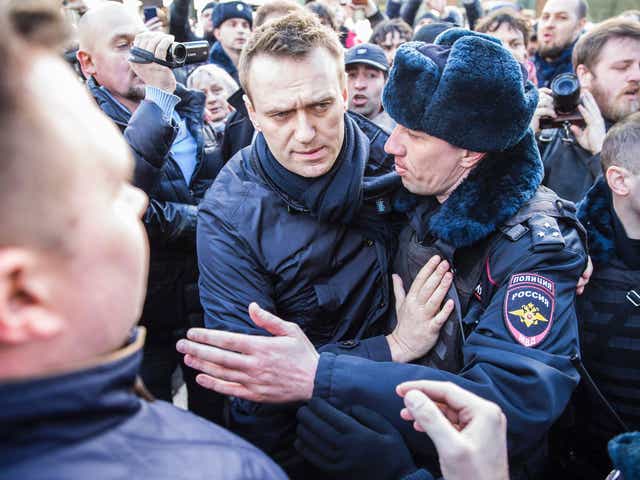 Police officers detaining Kremlin critic Alexei Navalny during an unauthorised anti-corruption rally in central Moscow