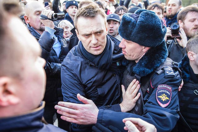 Police officers detaining Kremlin critic Alexei Navalny during an unauthorised anti-corruption rally in central Moscow
