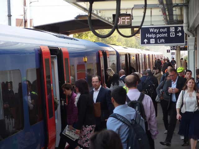 Standing innovation: Rush-hour commuters will be able to use a smartphone app to find the best place to stand on the platform at stations such as Surbiton