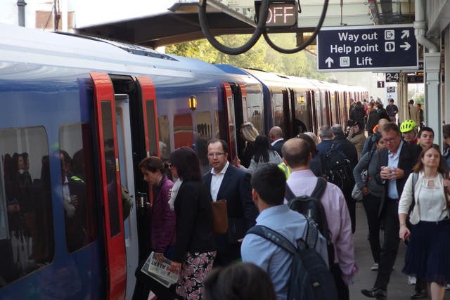 Standing innovation: Rush-hour commuters will be able to use a smartphone app to find the best place to stand on the platform at stations such as Surbiton