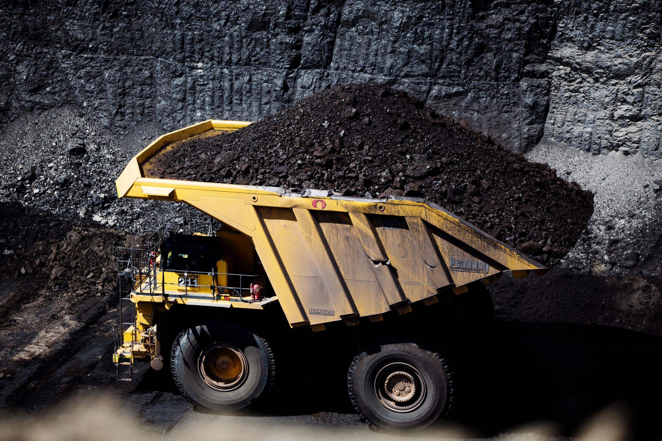 A truck hauls a vast pile of coal at a mine near Gillette, Wyoming