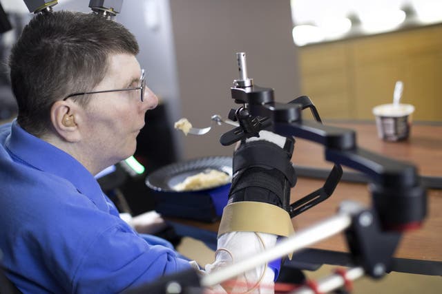 Despite being paralysed from the shoulders down, Bill Kochevar can feed himself by controlling his arm using a brain-computer interface