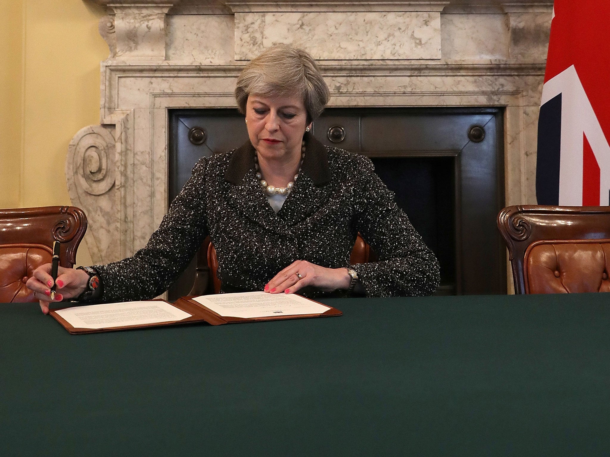 Theresa May signs the official letter to European Council President Donald Tusk invoking Article 50