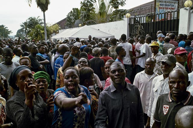 Supporters of the Congolese main opposition part Union for Democracy and Social Progress (UDPS) shout slogans as they gather outside the residence of the late veteran opposition leader Etienne Tshisekedi in the Limete Municipality in Kinshasa