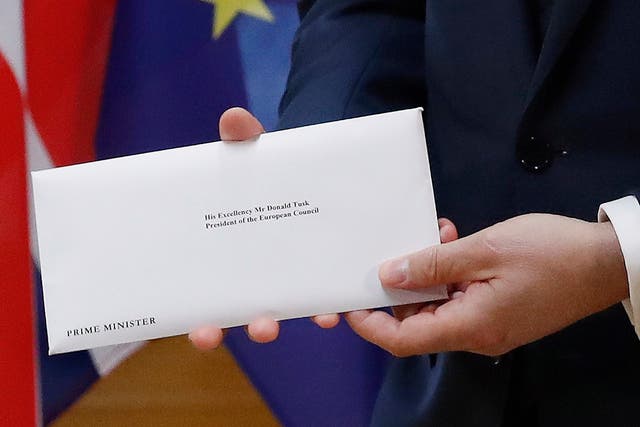 EU Council President Donald Tusk holds the official letter from Theresa May, beginning the withdrawal process from the EU