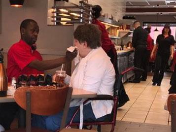 Keshia Dotson's photo of Joe Thomas wiping a disabled woman's mouth in an Illinois restaurant