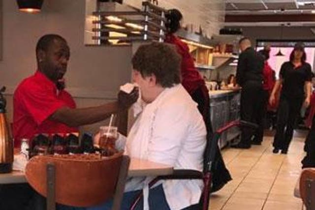 Keshia Dotson's photo of Joe Thomas wiping a disabled woman's mouth in an Illinois restaurant