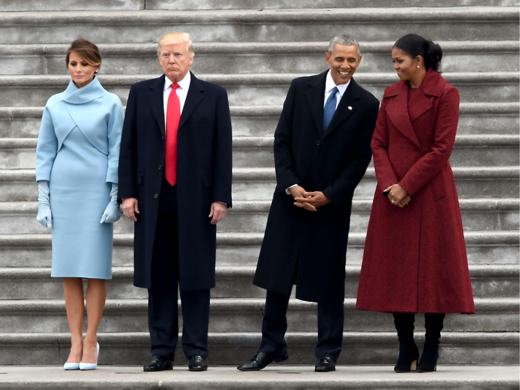 The Obamas and Trumps stand on the East front steps of the US Capitol after inauguration ceremonies on January 20, 2017 in Washington, DC