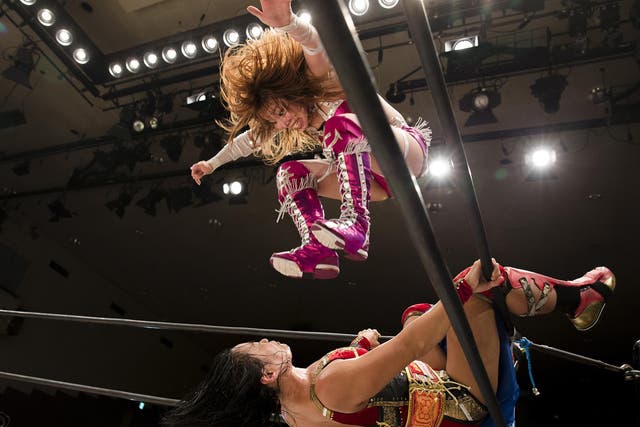 Wrestler Kairi Hojo jumps at her opponent Mieko Satomura during their Stardom female professional wrestling show at Korakuen Hall, Tokyo